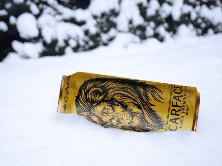 High alcohol beer bottle with deep golden color, thick foam head, and chilled condensation, highlighting strong flavor and intense character.